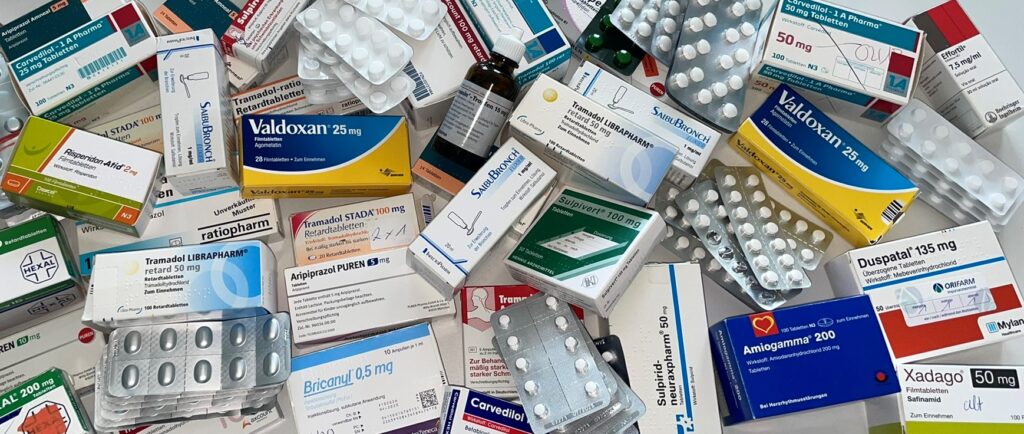 The picture shows many different types of packaging for medicines and blister packs.